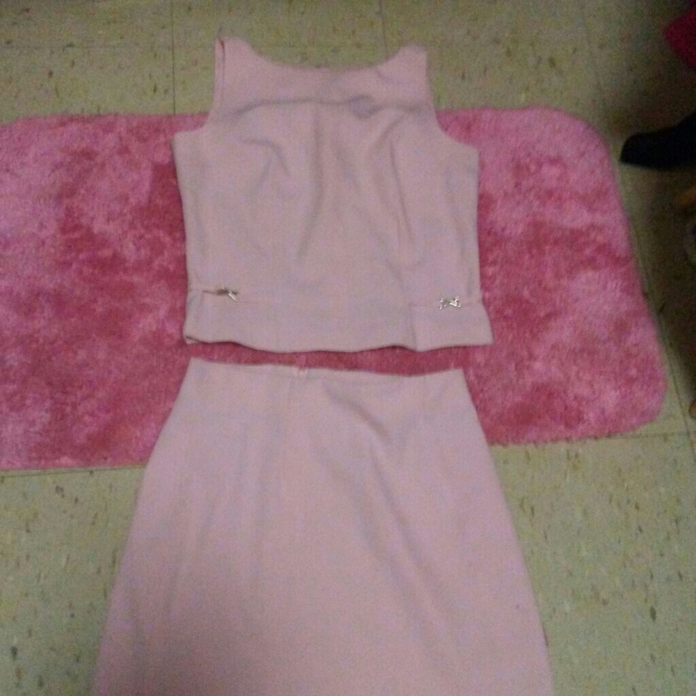 A two piece pink shirt and skirt